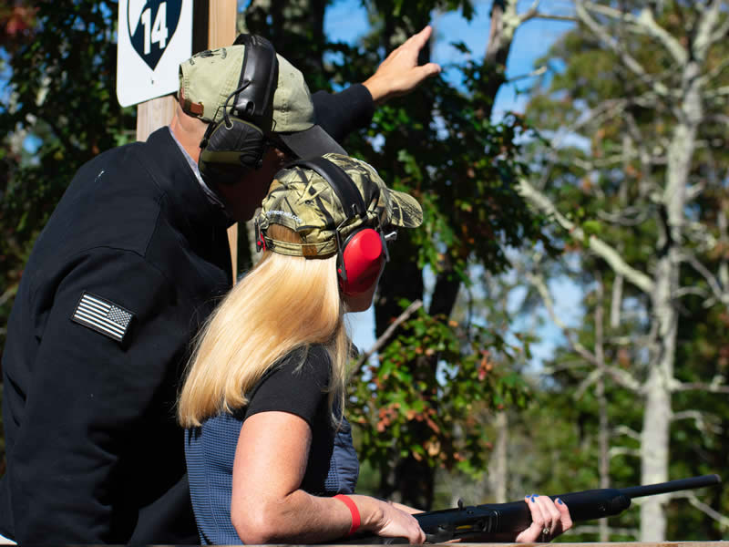 An instructor guiding a shooter at a station